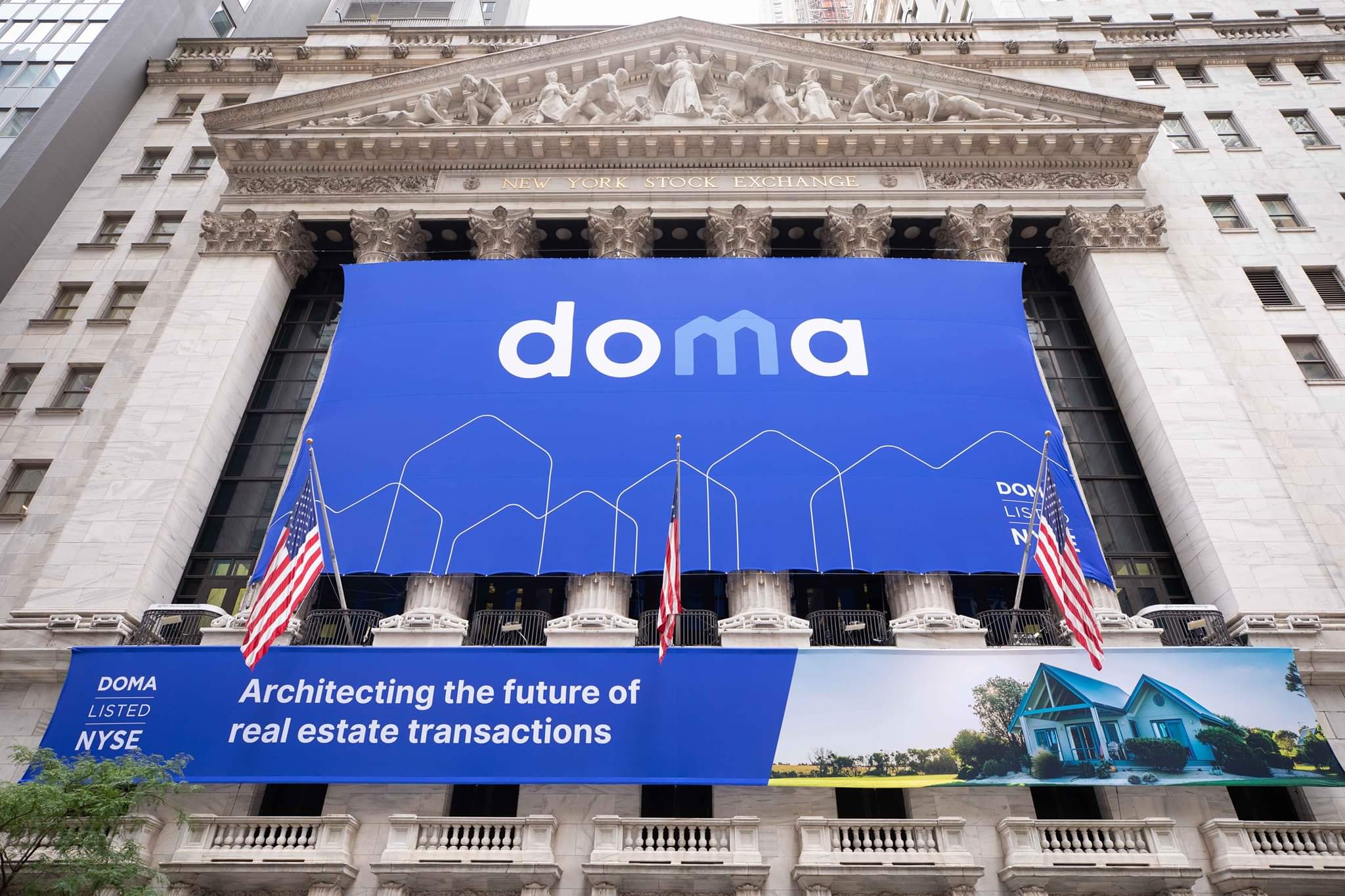 The Doma banner across the front of the New York Stock Exchange, above a second banner reading Doma, listed NYSE, Architecting the future of real estate transactions